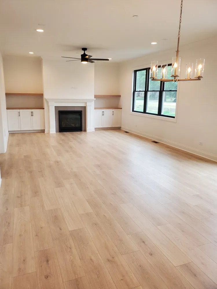 new light brown hardwood flooring in the living room with a fireplace