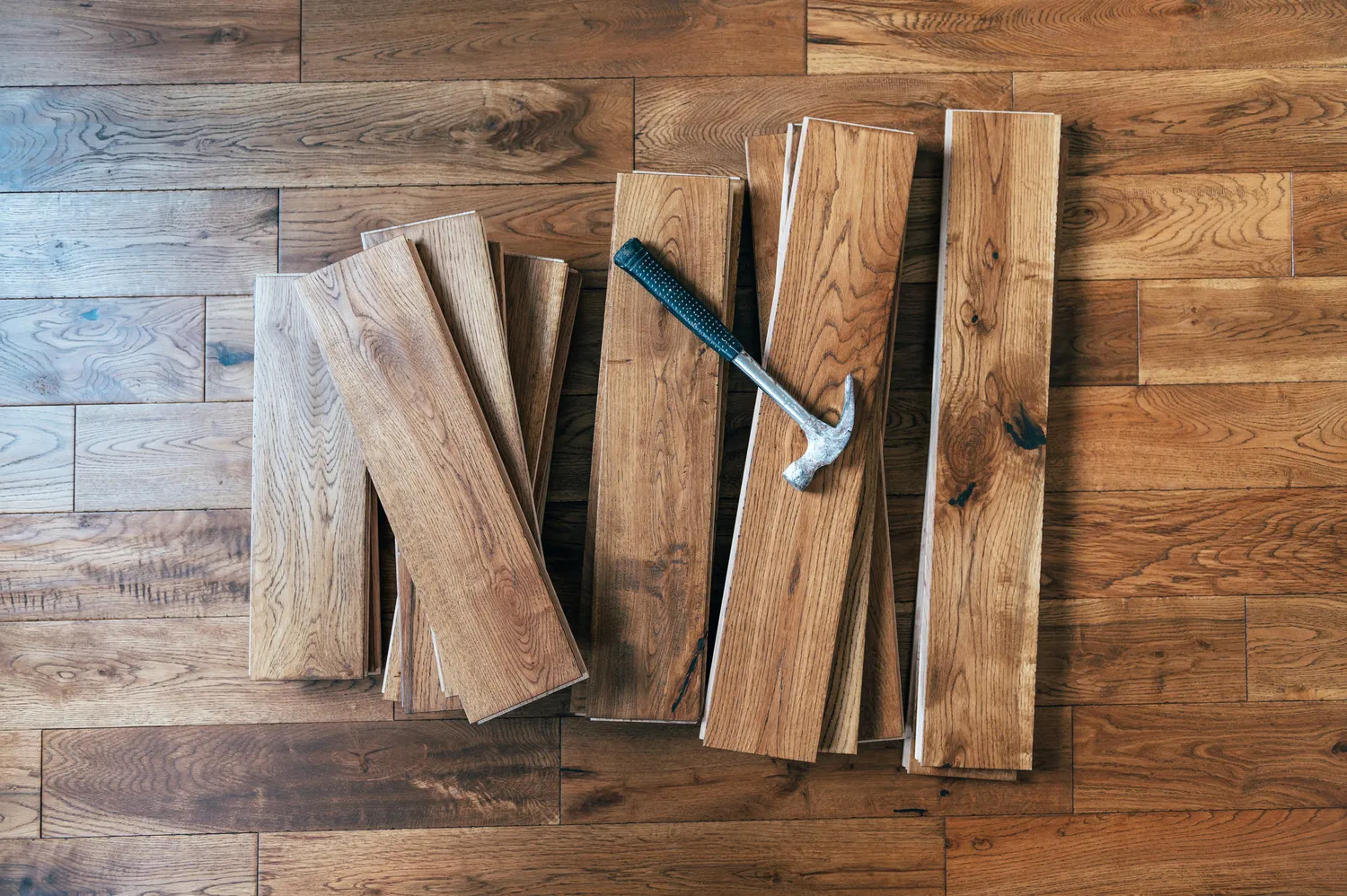 hardwood flooring with the hammer after flooring repairs